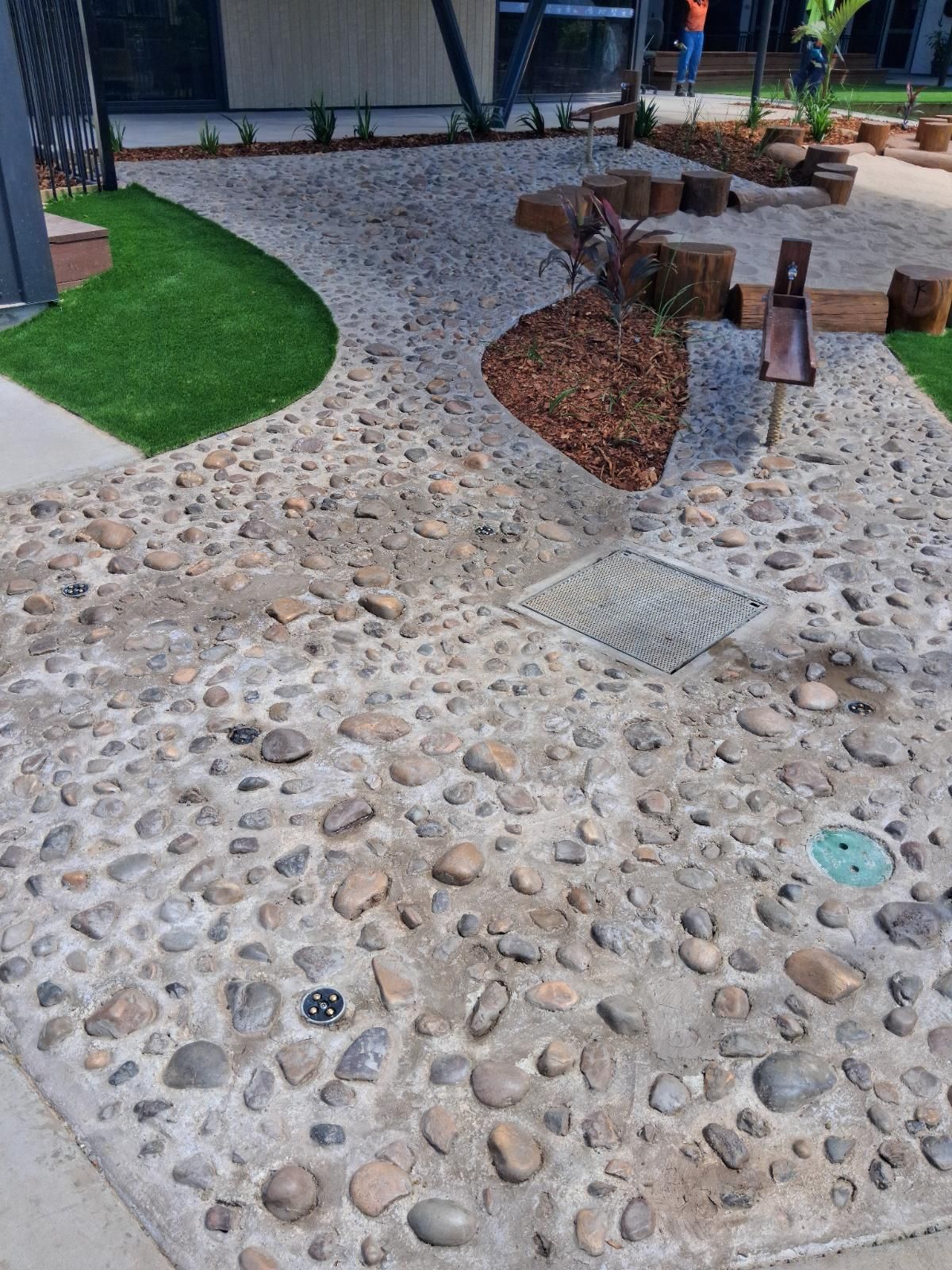 Completed landscaping project showing neat garden beds and tidy lawn in a Parap residential yard after work by iScape NT